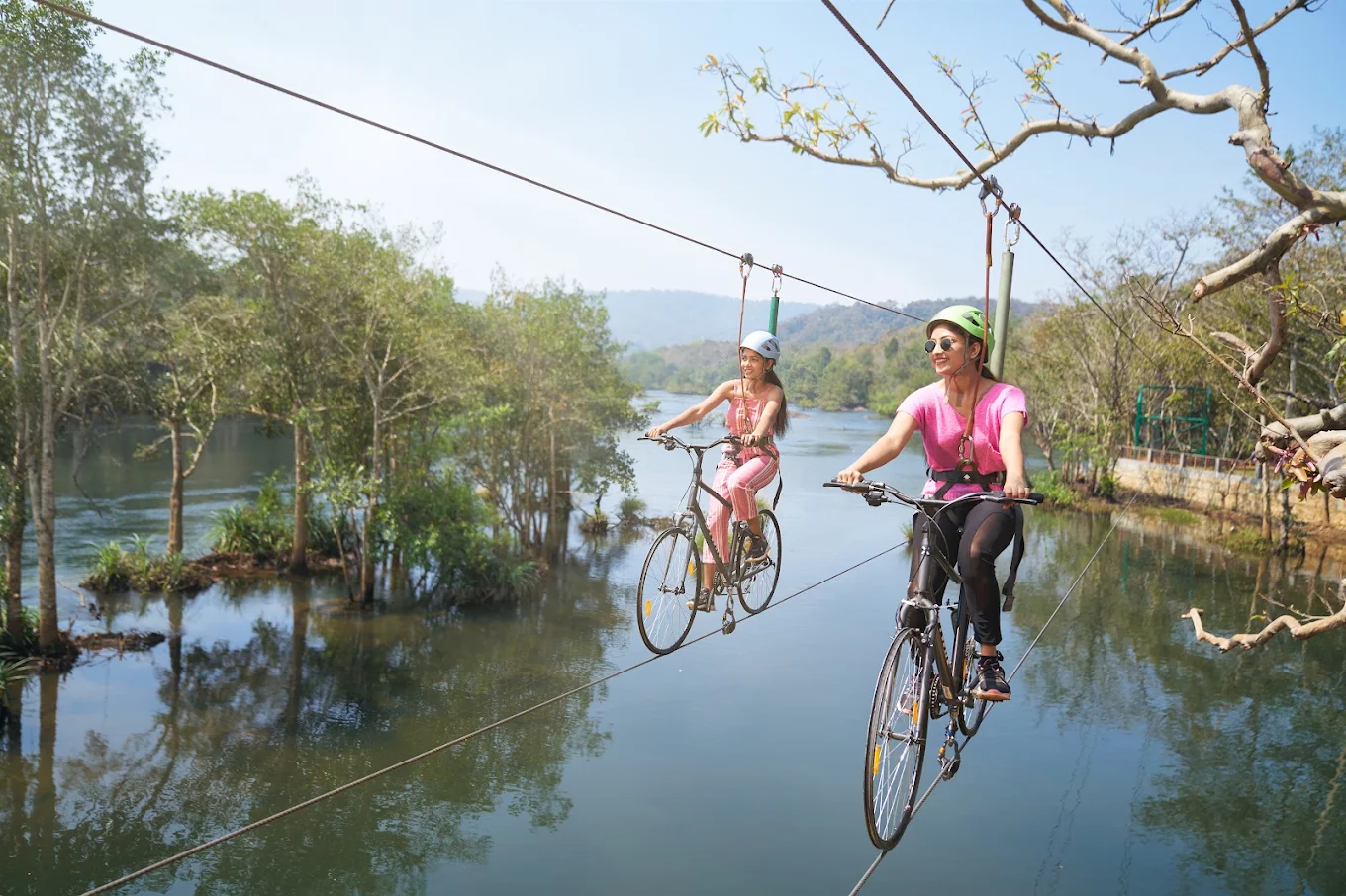 Air cycling over the river at Whistling Woodzs Jungle Resort